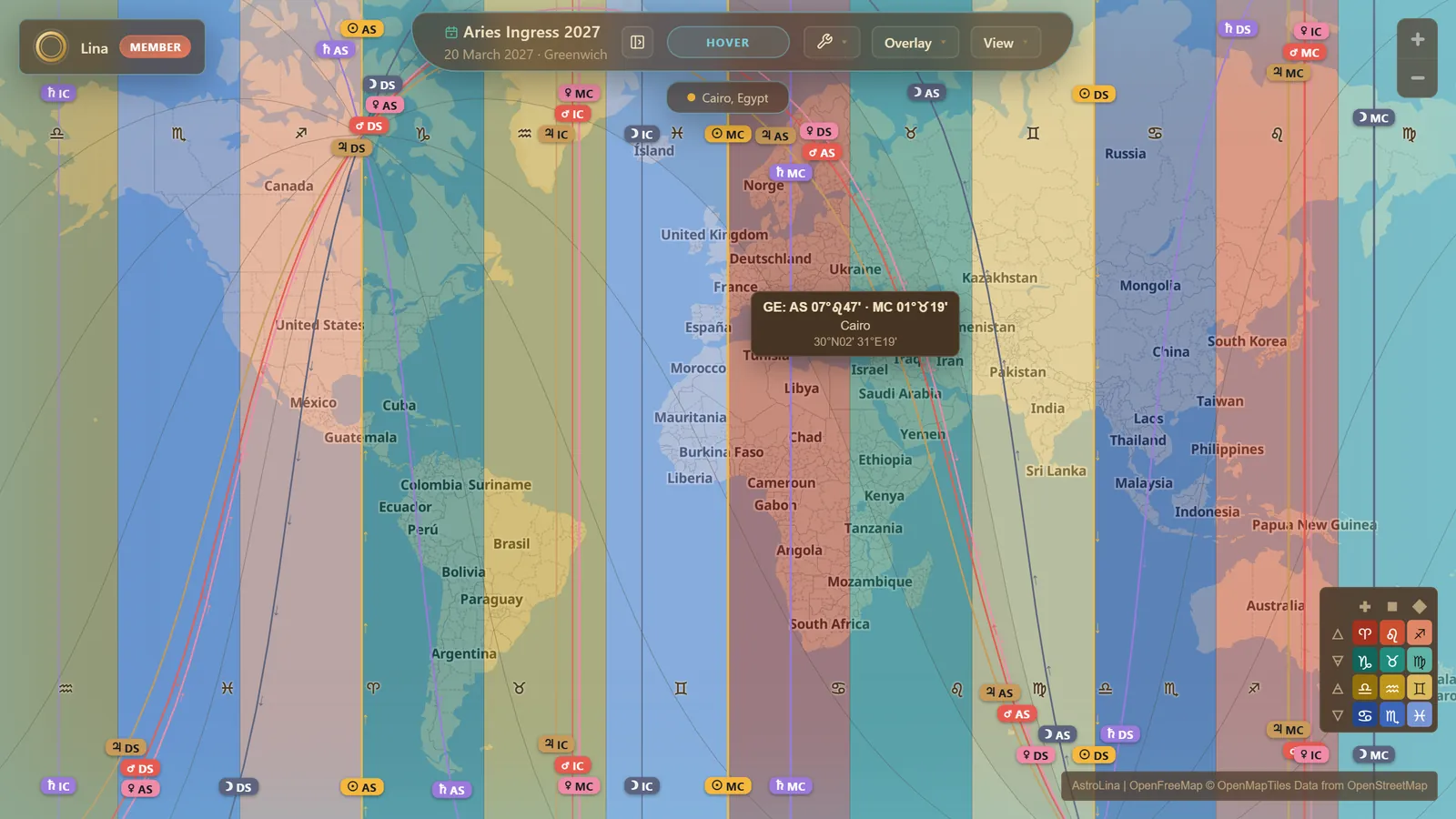 A geodetic world map shaded in twelve MC zones by element and modality, the signs along the top, with the faint Ascendant curves, the lines of the Aries Ingress 2027 chart, the zone legend in the corner, and a hover readout giving Cairo's geodetic Ascendant and Midheaven